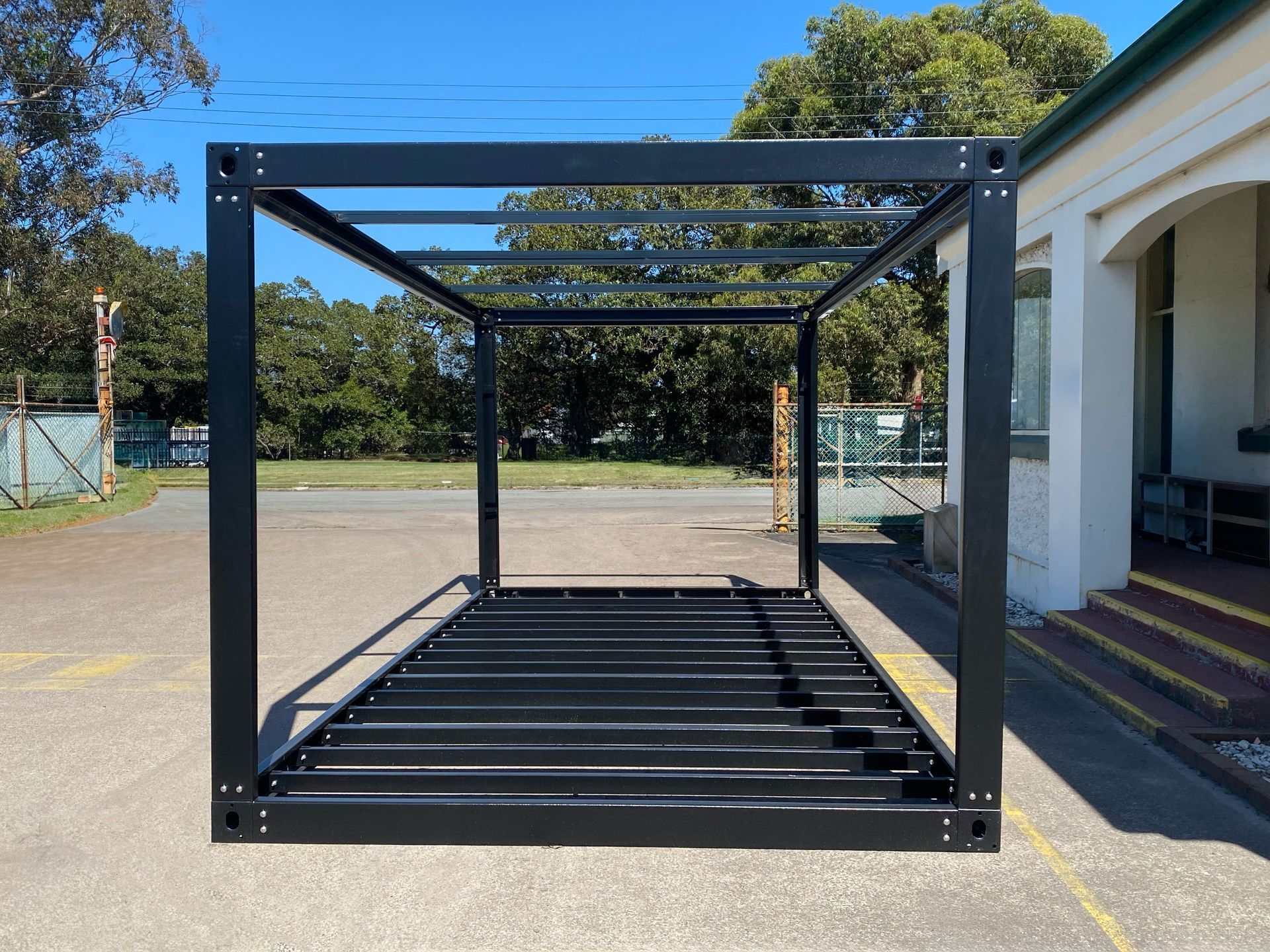 Black Metal Cargo Cage on a Trailer — East Coast Containers Shipping Containers and Transport in Chevallum, QLD
