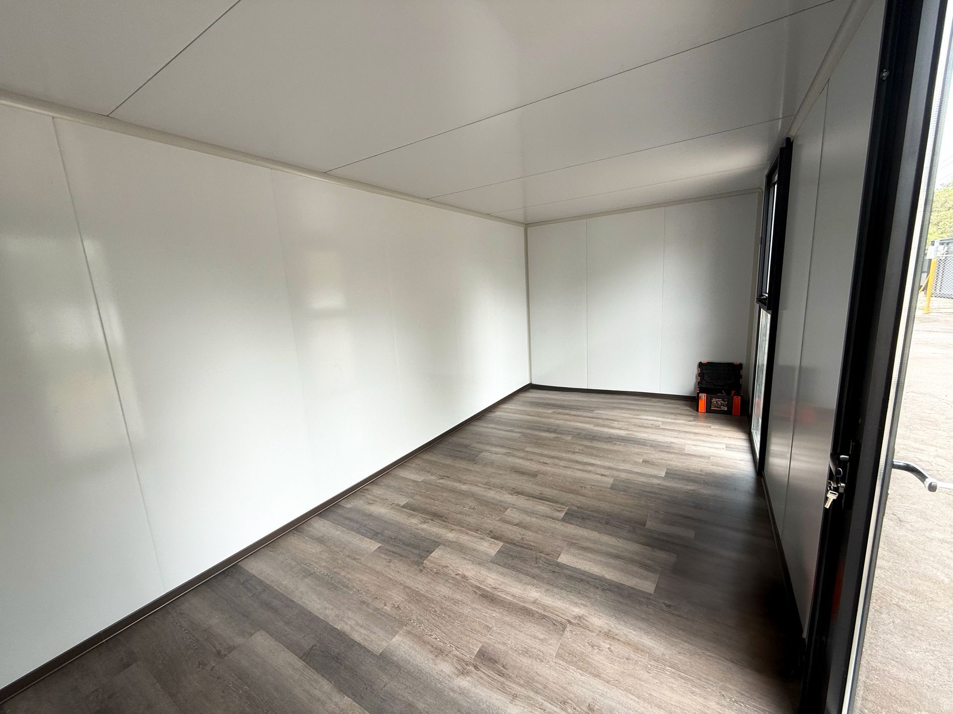 Empty White Room With Wood-look Floor — East Coast Containers Shipping Containers and Transport in Chevallum, QLD