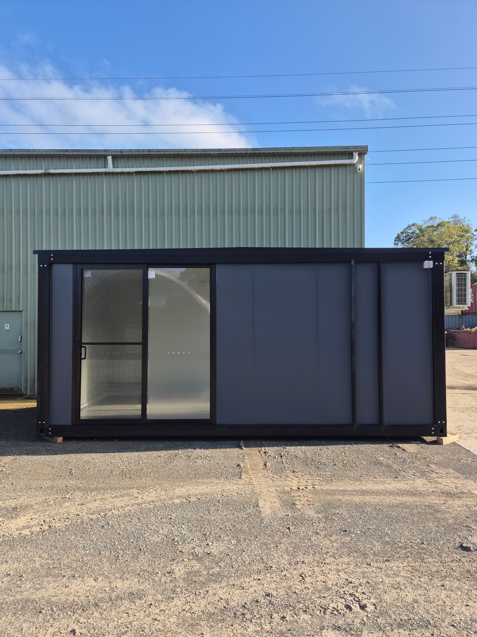 Black Shipping Container With Glass Doors — East Coast Containers Shipping Containers and Transport in Chevallum, QLD