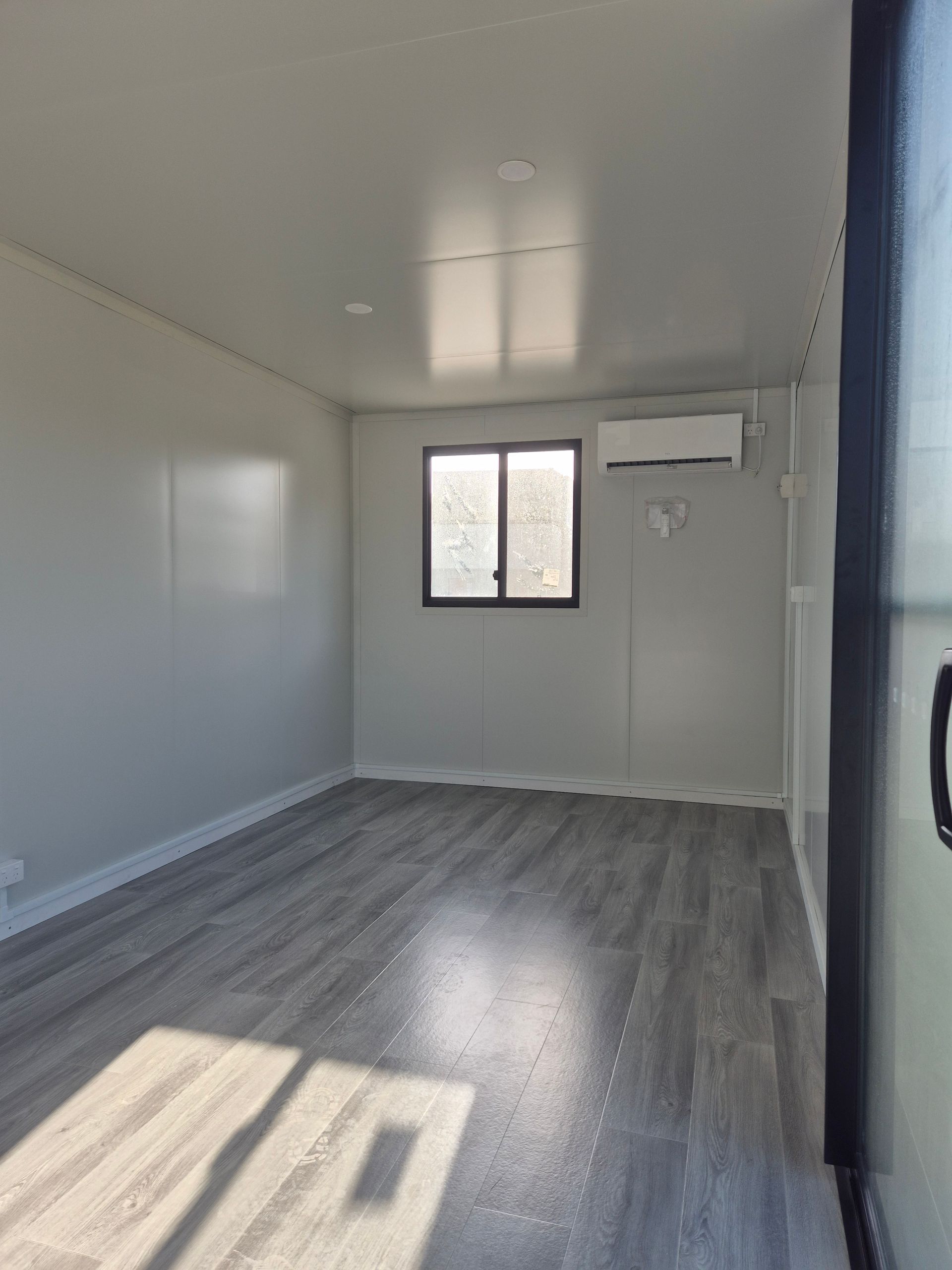 Empty White Room With Gray Wood — East Coast Containers Shipping Containers and Transport in Chevallum, QLD