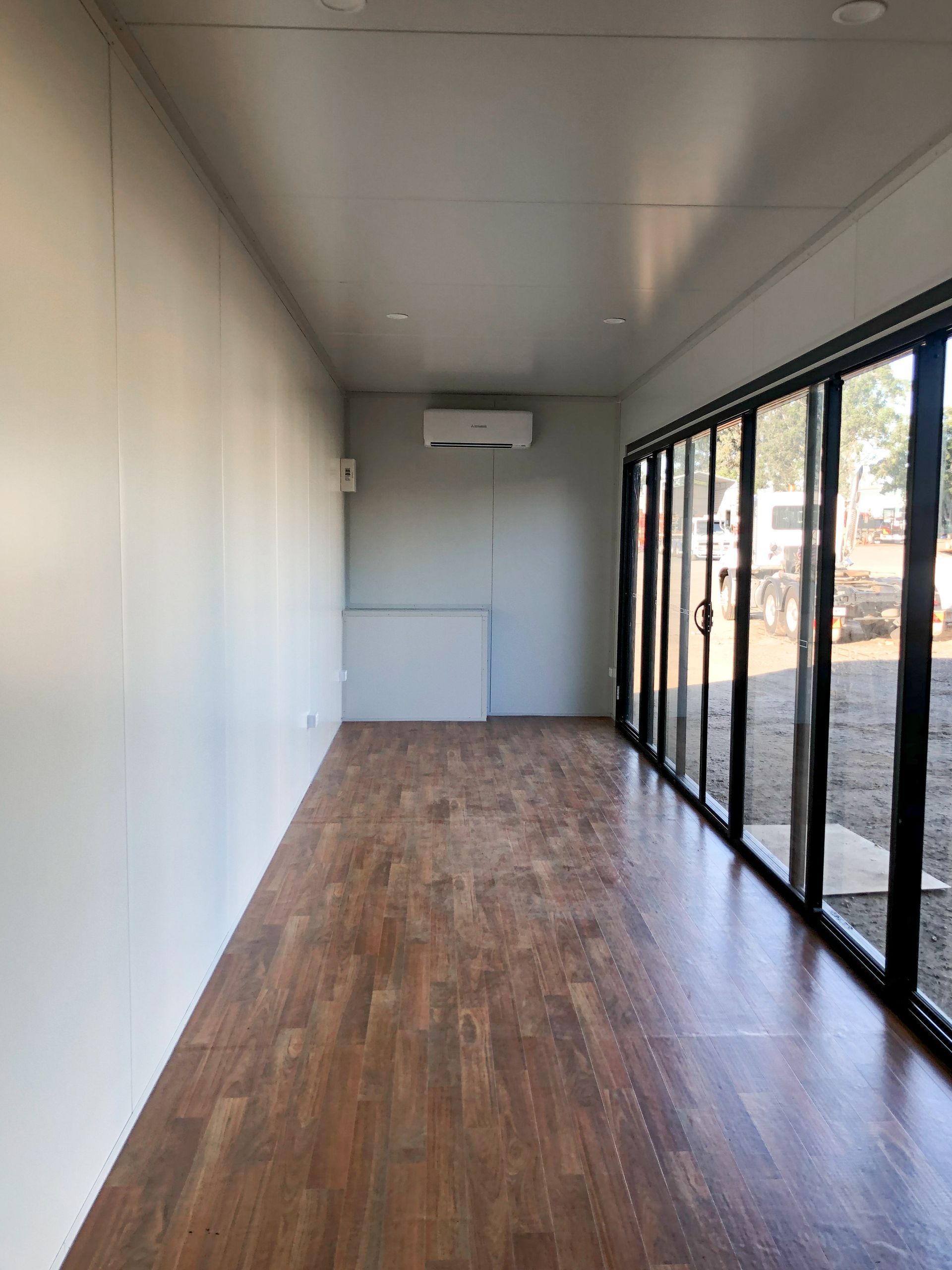 Empty Narrow Room With Wood Floors — East Coast Containers Shipping Containers and Transport in Chevallum, QLD