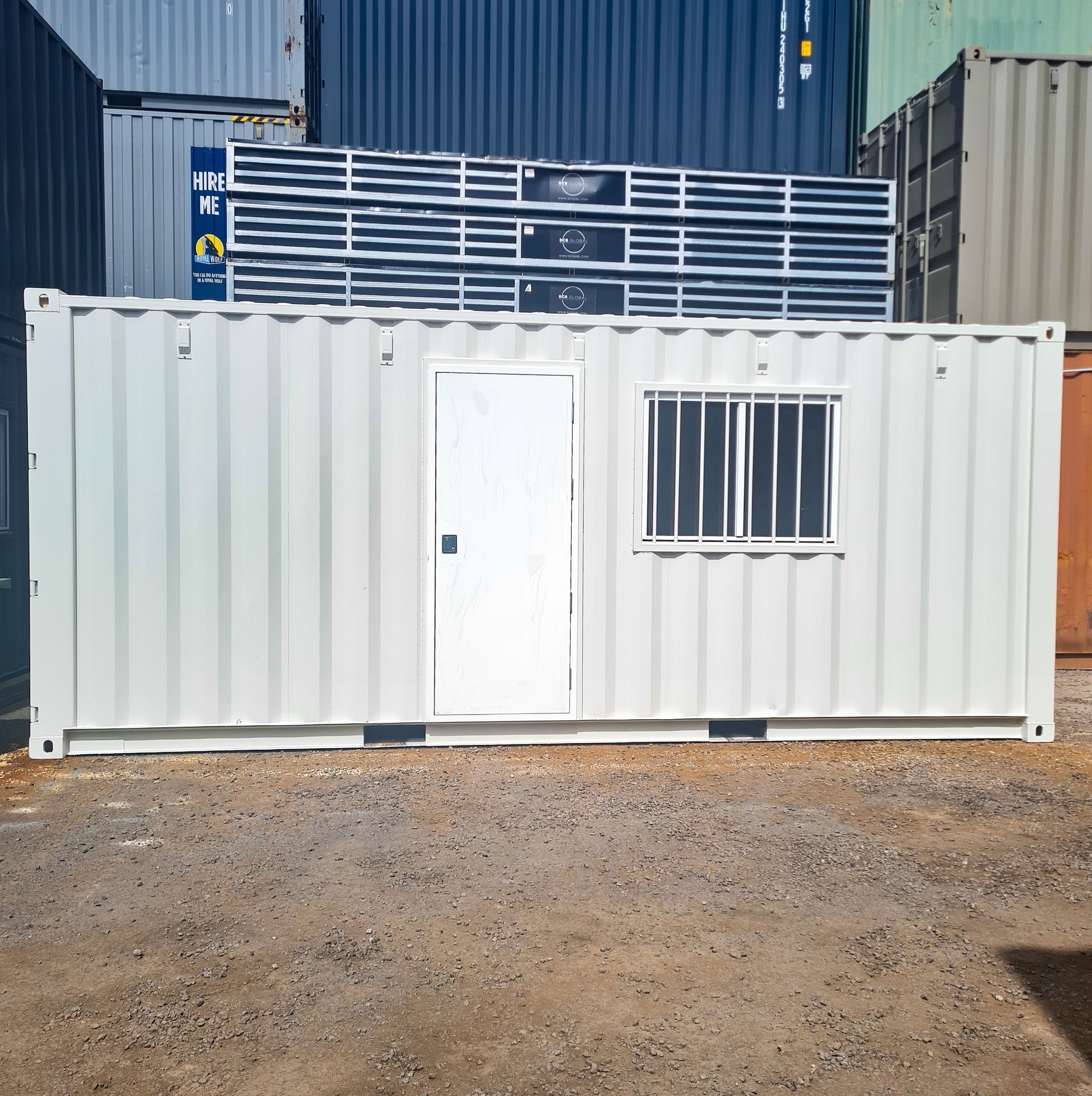 White portable container office with door and barred window — East Coast Containers Shipping Containers and Transport in Chevallum, QLD