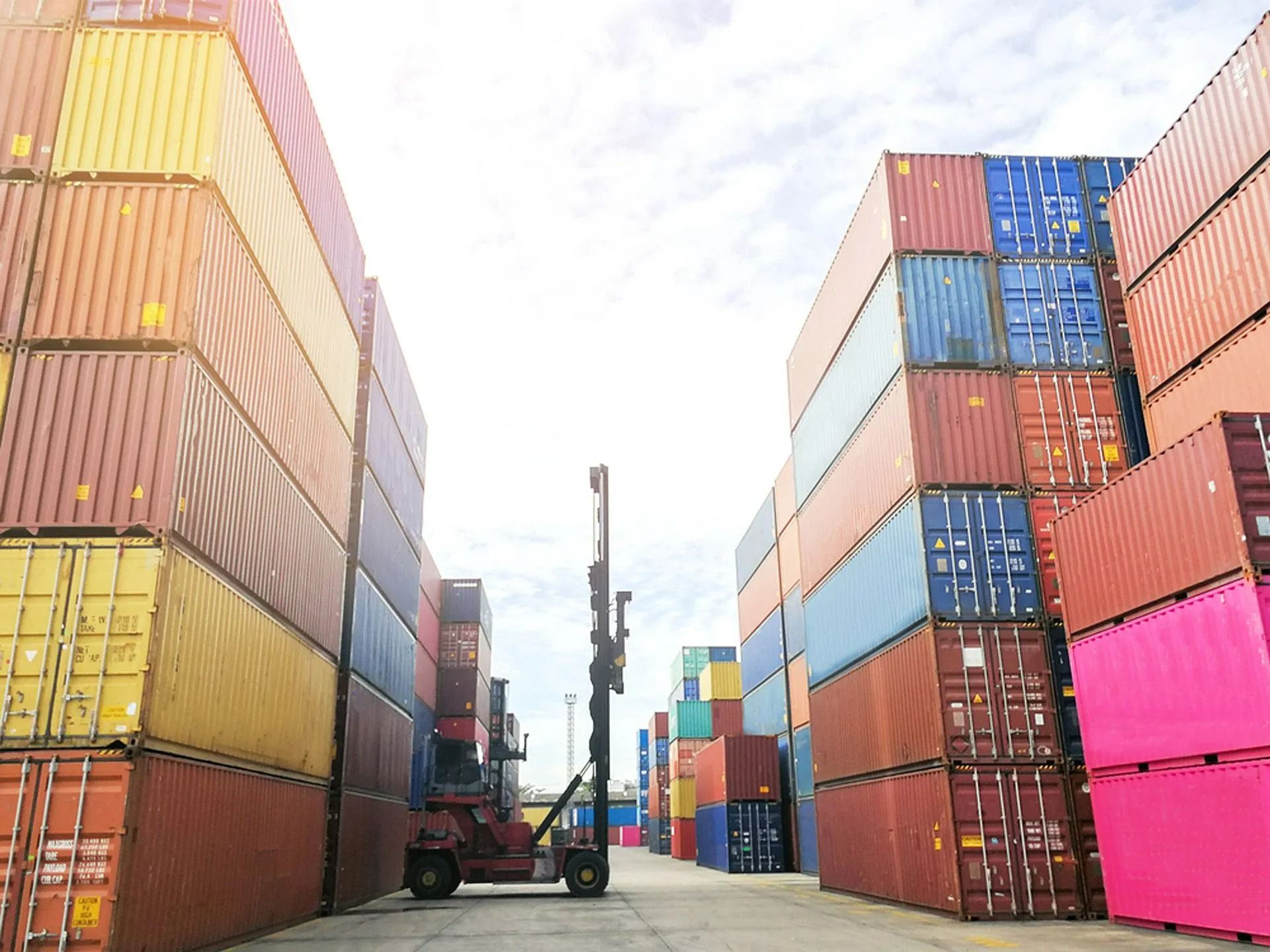 A Reach Stacker Lifts a Shipping Container — East Coast Containers Shipping Containers and Transport in Chevallum, QLD A Reach Stacker Lifts a Shipping Container — East Coast Containers Shipping Containers and Transport in Chevallum, QLD