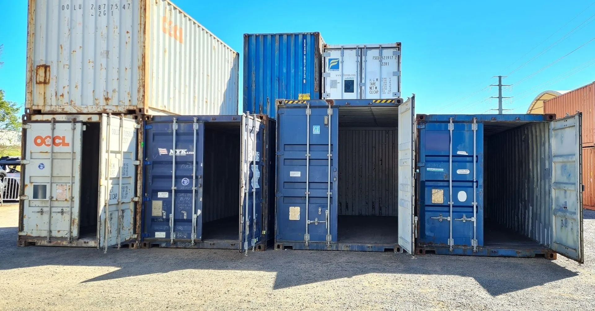 A Row of Open, Colorful Shipping Containers — East Coast Containers Shipping Containers and Transport in Chevallum, QLD A Row of Open, Colorful Shipping Containers — East Coast Containers Shipping Containers and Transport in Chevallum, QLD