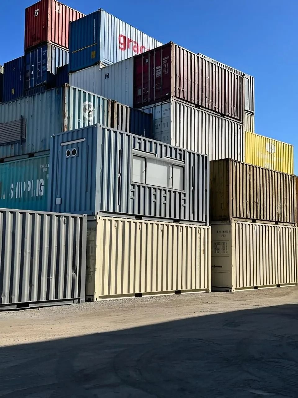 A Stack of Colorful Metal Shipping Containers — East Coast Containers Shipping Containers and Transport in Chevallum, QLD A Stack of Colorful Metal Shipping Containers — East Coast Containers Shipping Containers and Transport in Chevallum, QLD