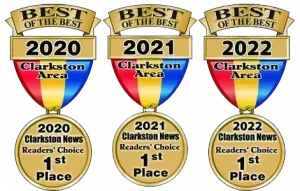 Three gold medallions, each with a shield, ribbon, and text: 