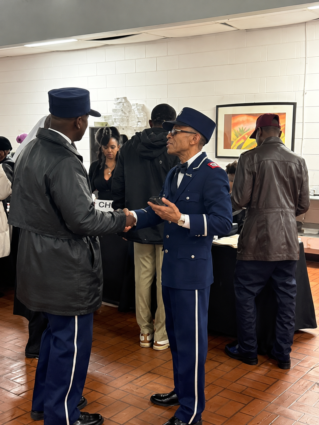 Soldier shakes hands with a person at a Veterans Resource Center desk