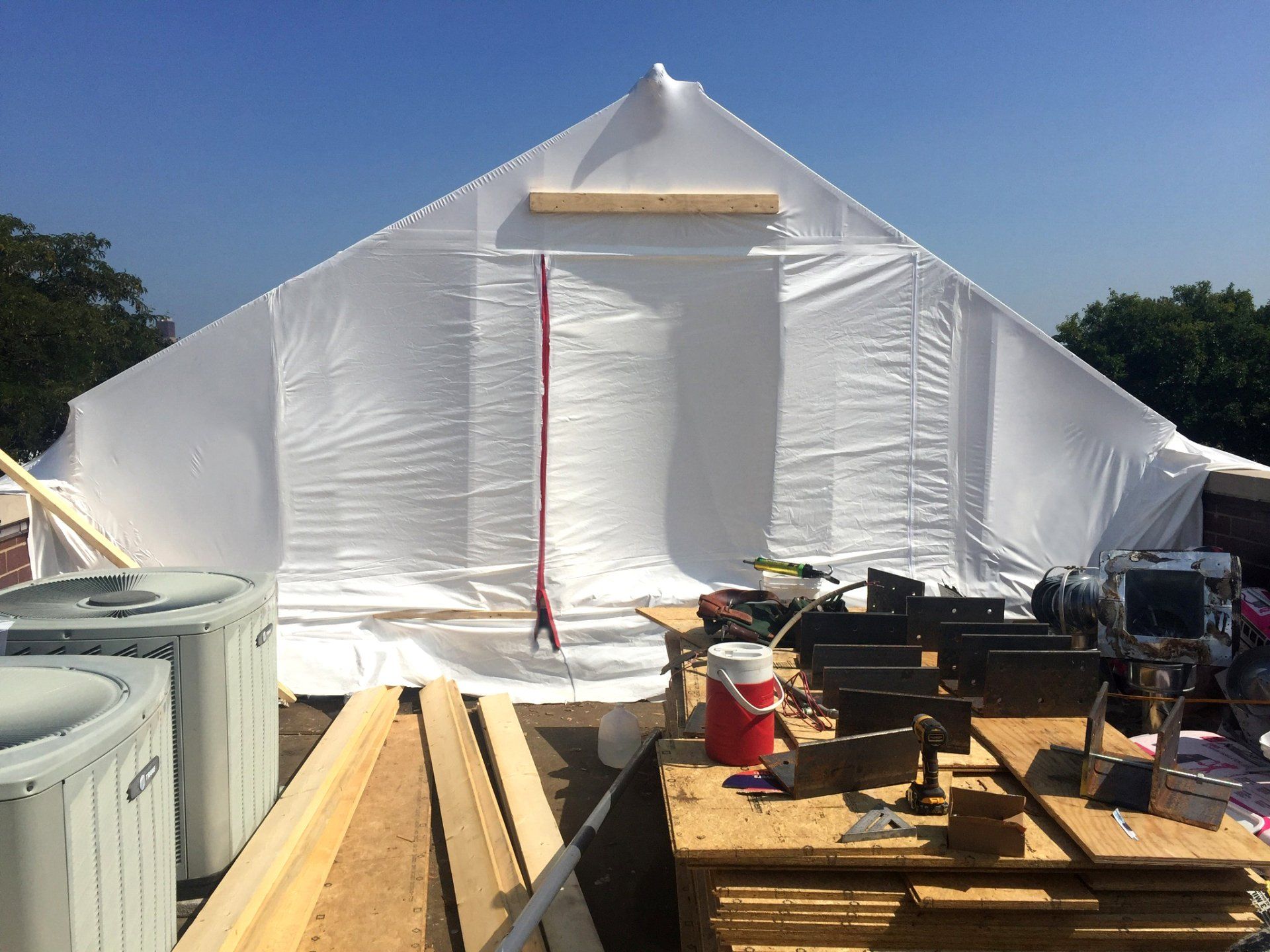 Exterior of closed 365 Construction Tent built by WickRight GC on flat roof repair project in Lincoln Park, Chicago.