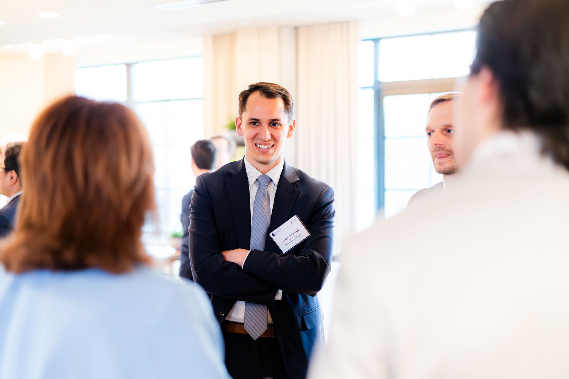 Candid networking moment, small group in conversation
