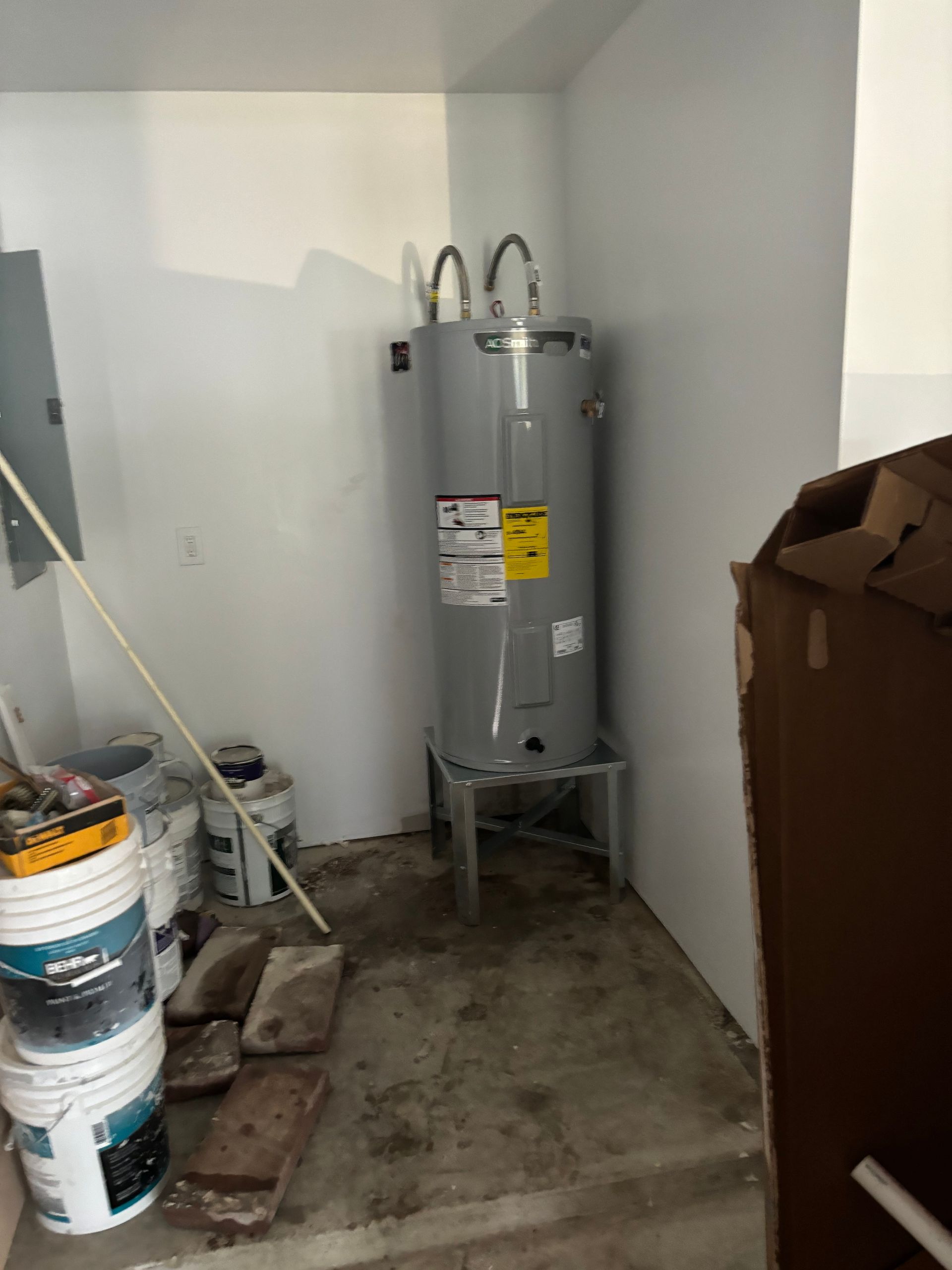 Technician inspecting a wall-mounted boiler with the cover open
