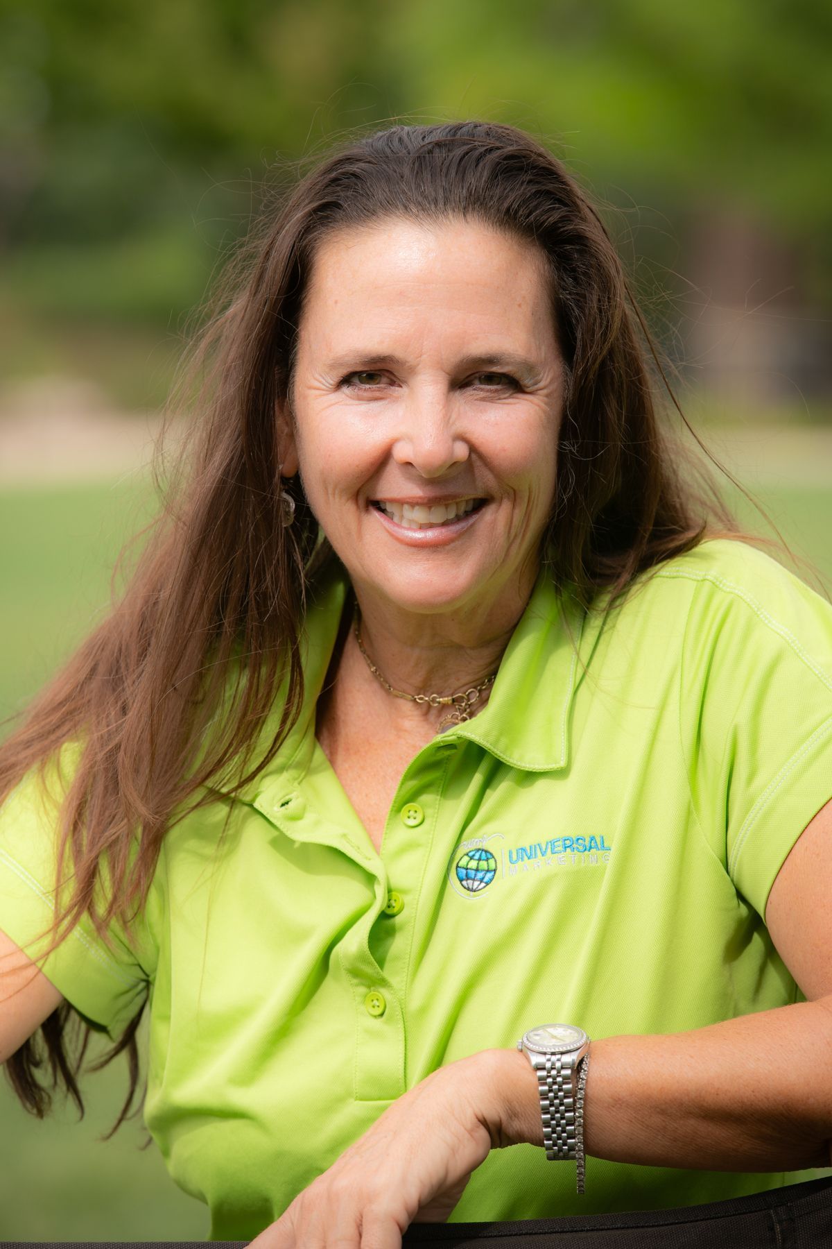 A woman in a black shirt is smiling for the camera.