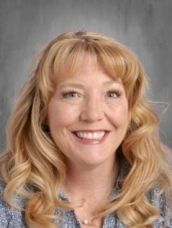 A woman with blonde hair is smiling for the camera.