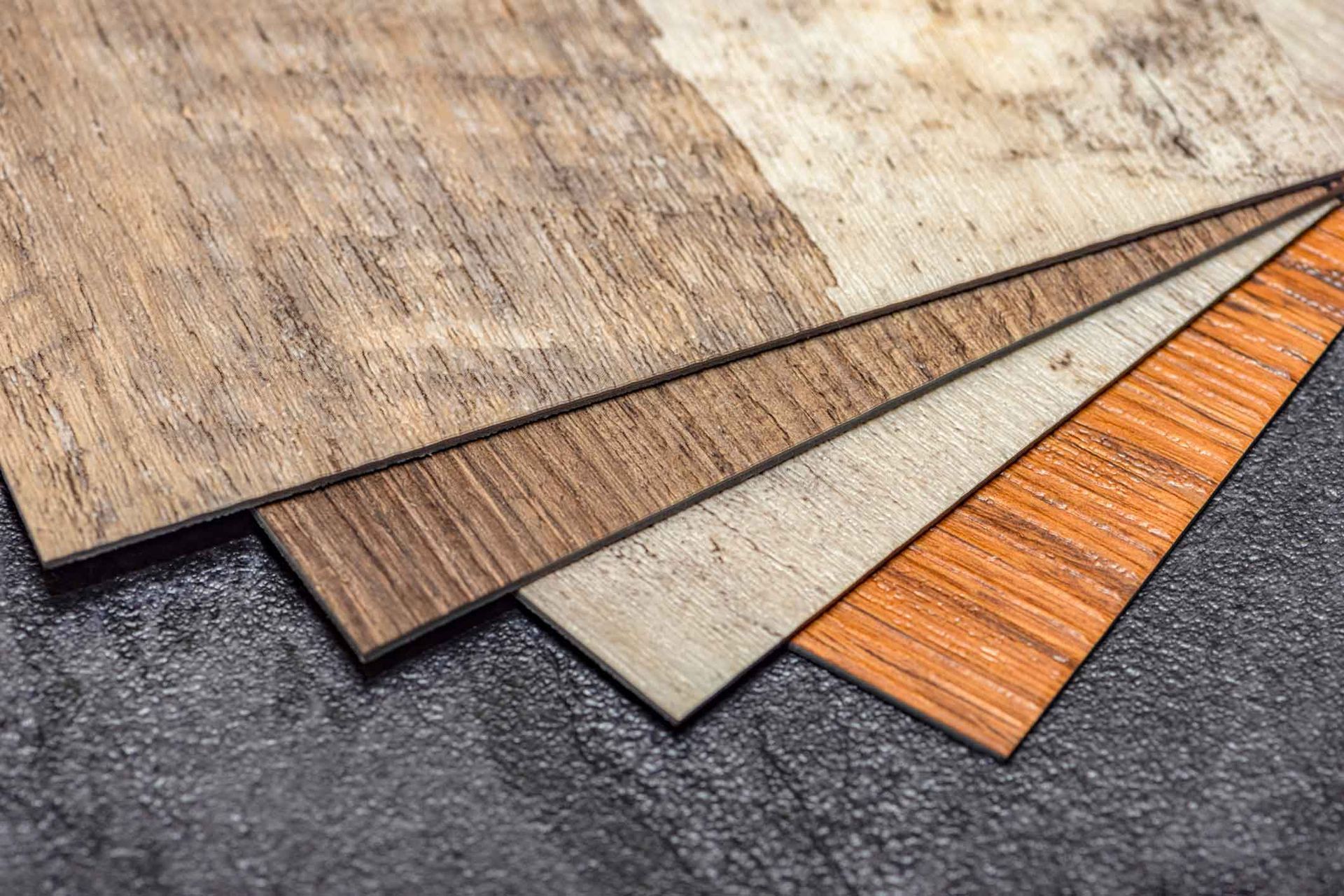 A stack of different types of wood sitting on top of each other on a table.
