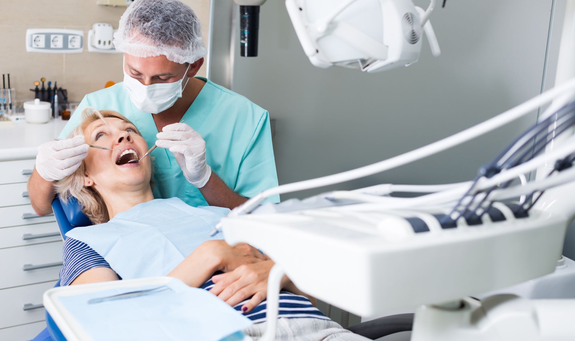 Dentist treating a patient. Dentist treating a patient.