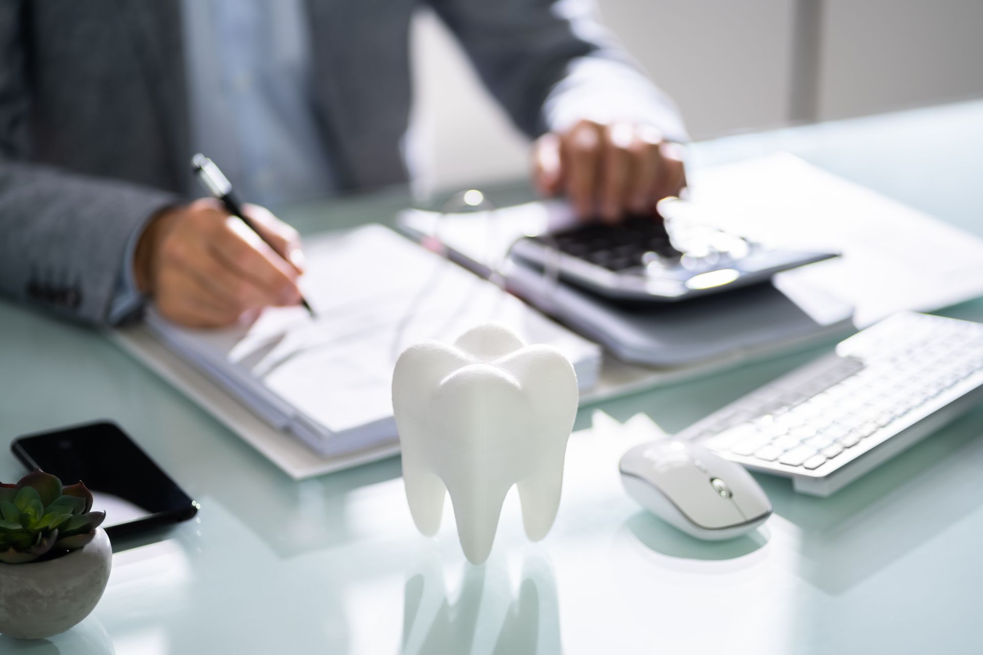 Close-up of a tooth model on an office desk, highlighting professional dentist services available. Close-up of a tooth model on an office desk, highlighting professional dentist services available.