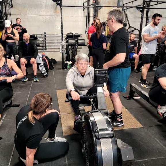 A group of people are doing exercises in a gym.
