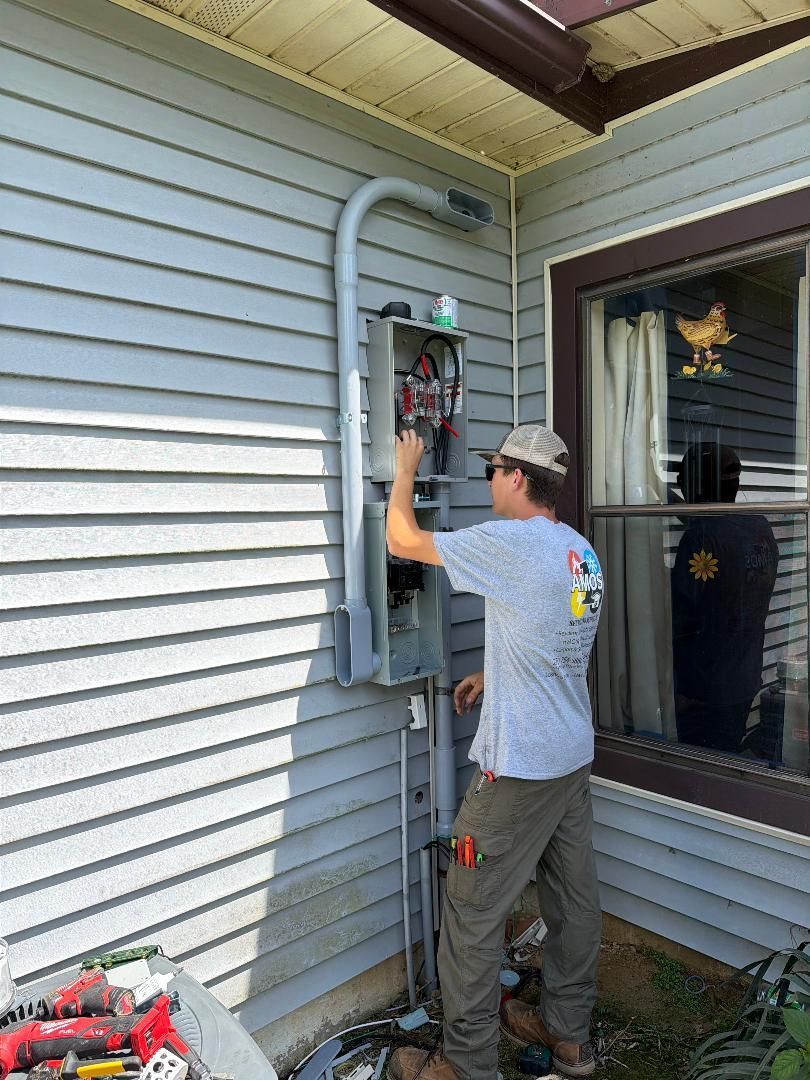 Two technicians servicing an outdoor HVAC unit beside a house