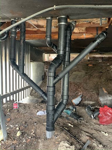 A bunch of pipes are connected to each other in a basement.