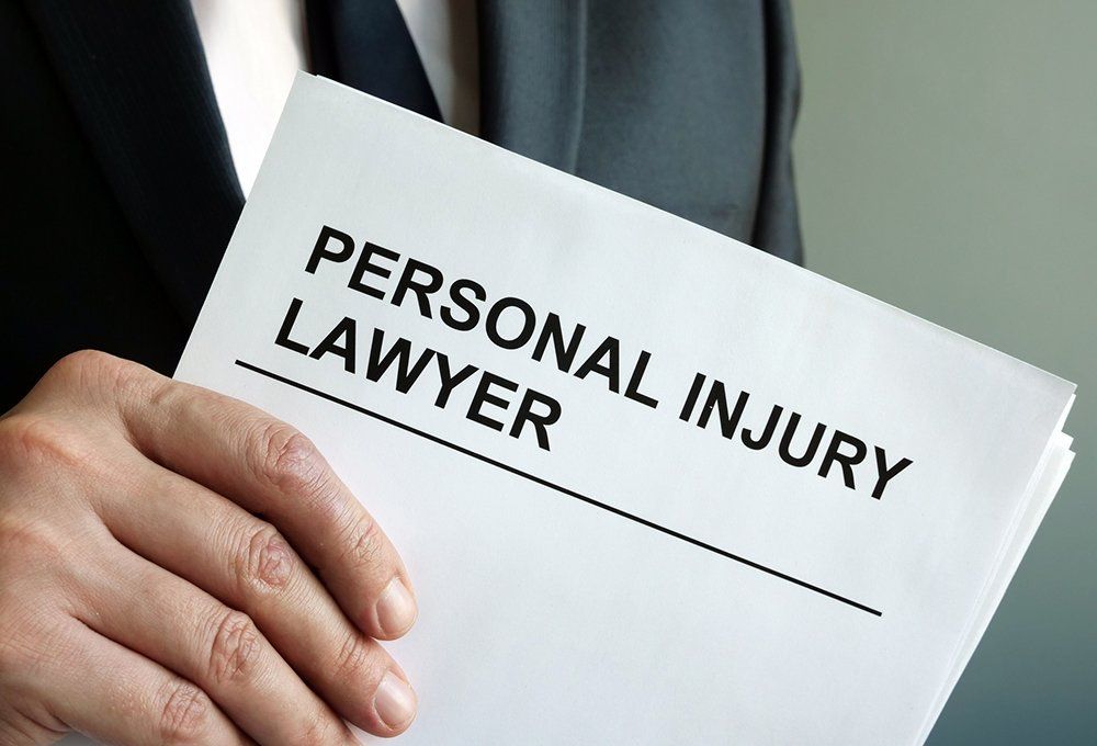 Lawyer Holding Paper Documents — Mobile, AL — Richard R. Williams LLC Lawyer Holding Paper Documents — Mobile, AL — Richard R. Williams LLC
