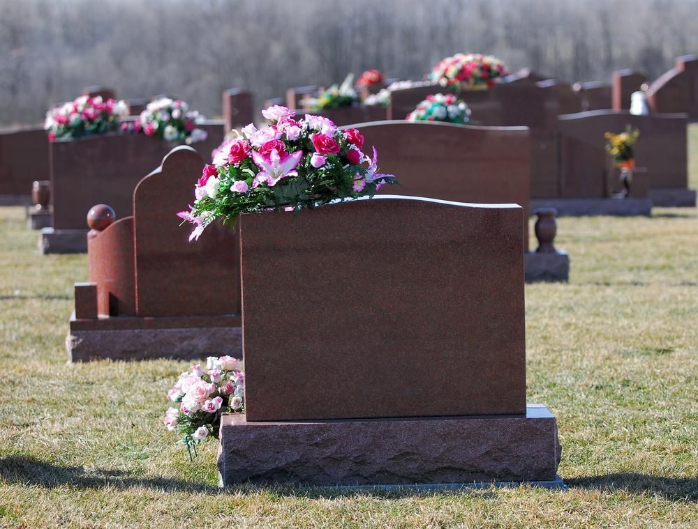 A Row of Graves in A Cemetery with Flowers on Them — Nick Locke Monuments in Nambucca Heads, NSW