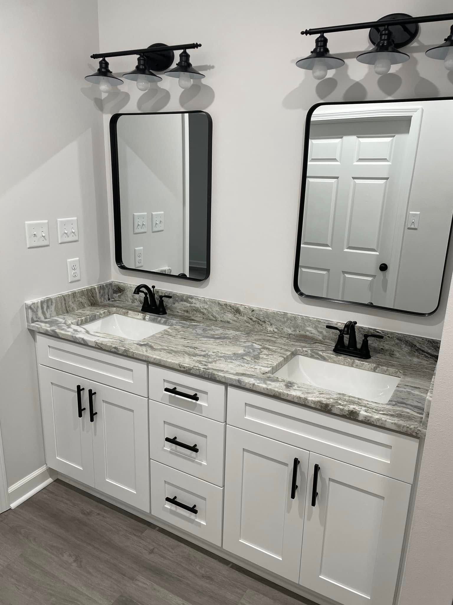 A bathroom with two sinks and two mirrors.