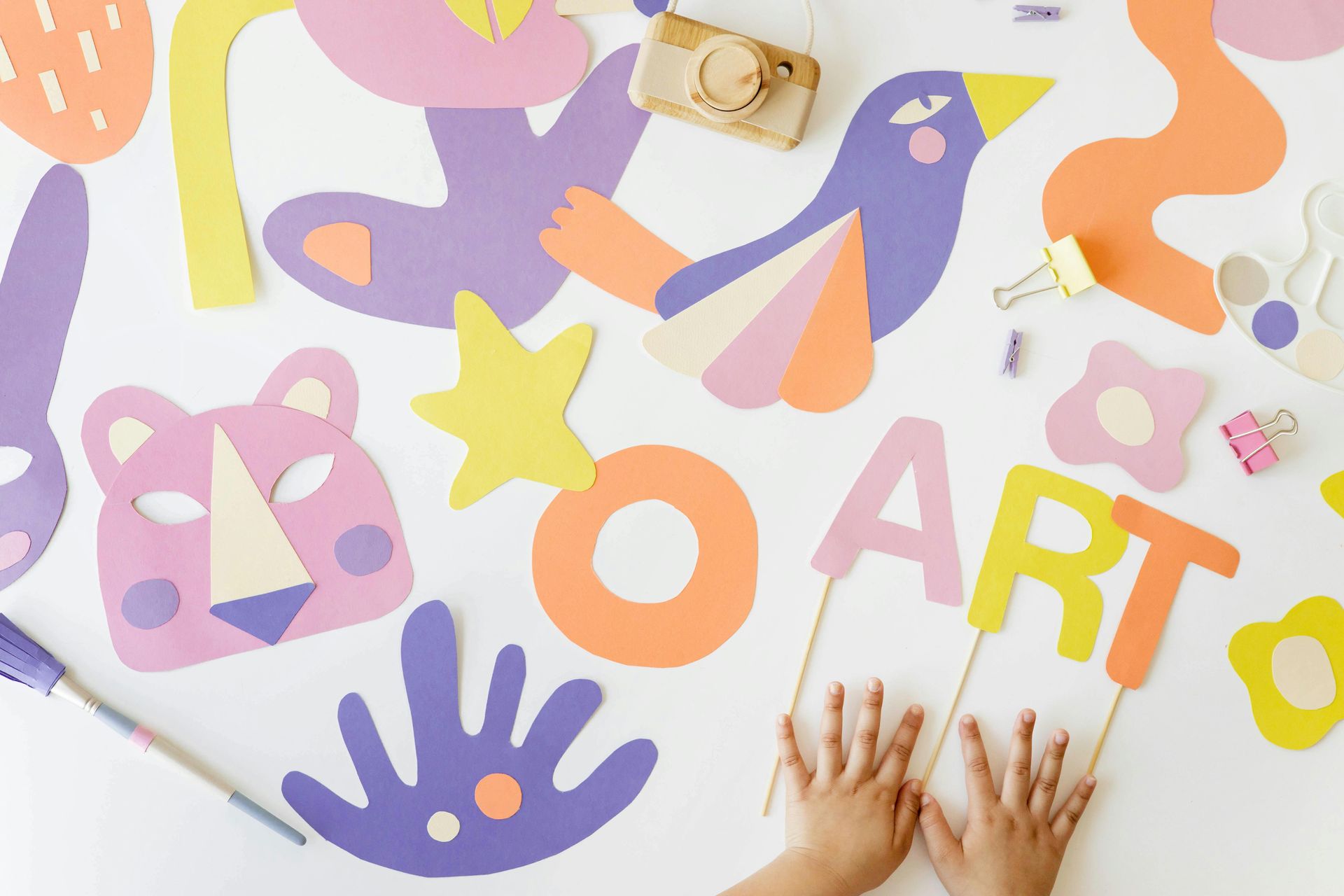 A child is making art with paper for a non-messy paper art project.