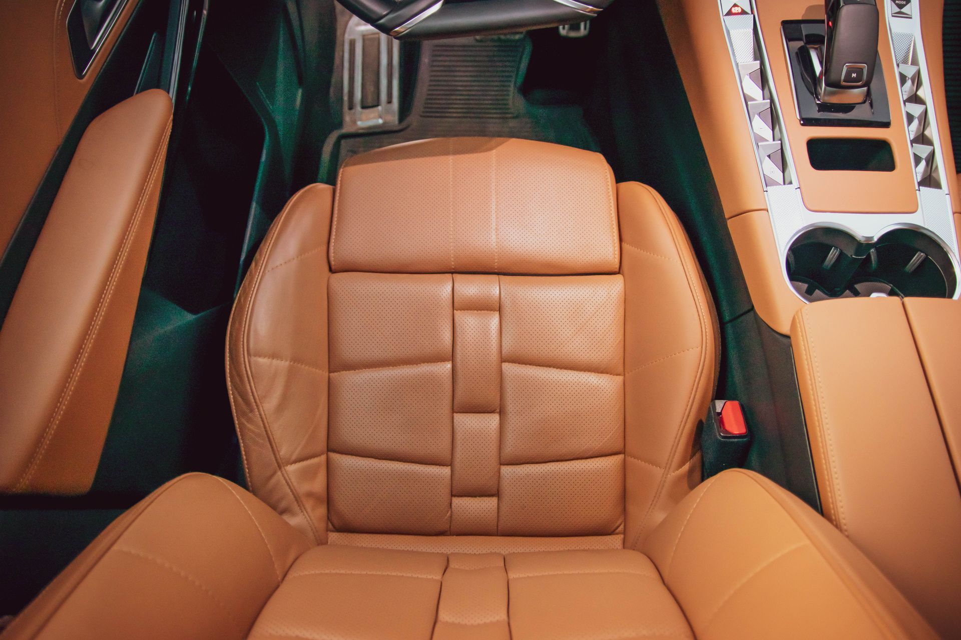 A man applying ceramic coating on the leather of the car seat.