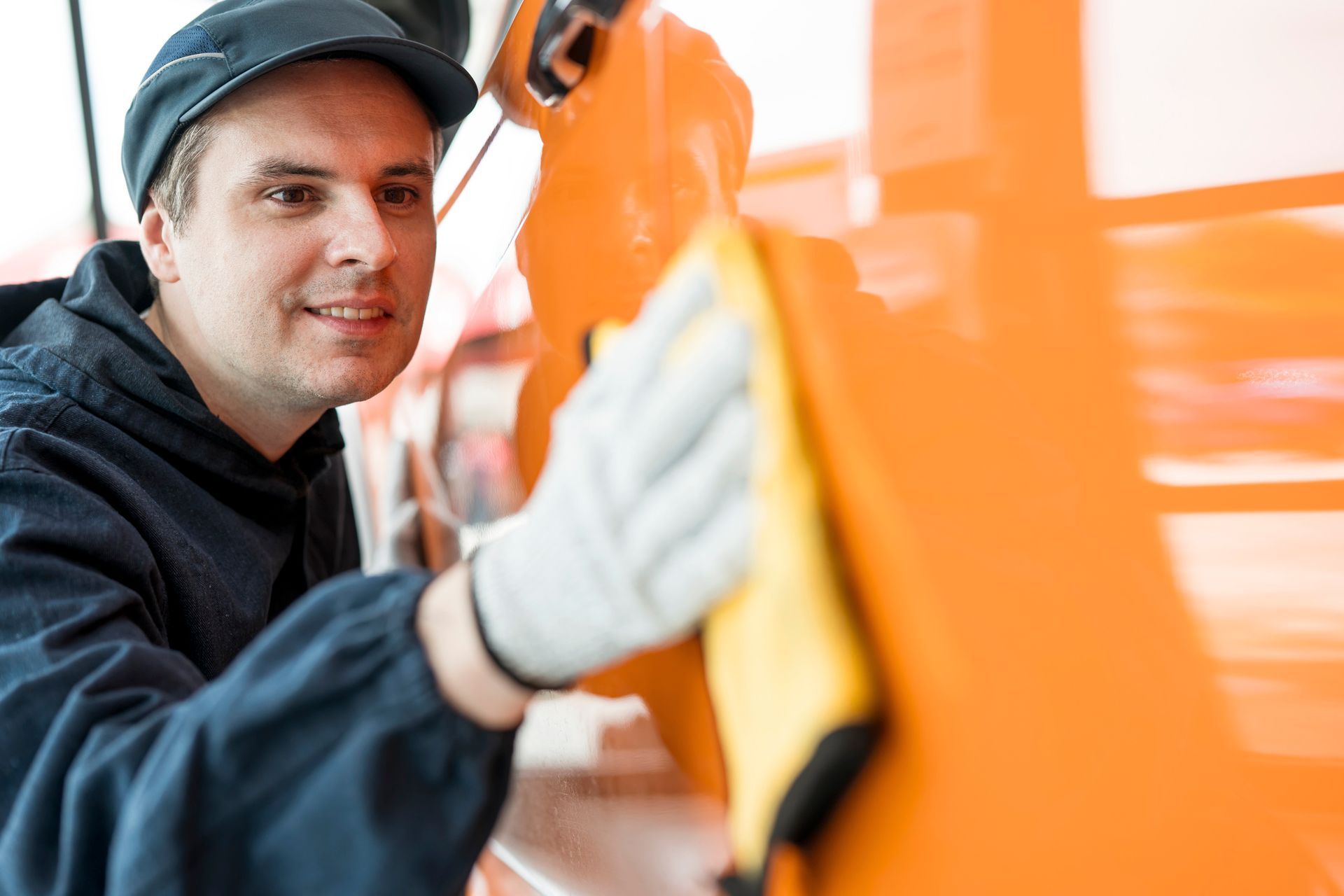 A person working on a car | Auto Detailing