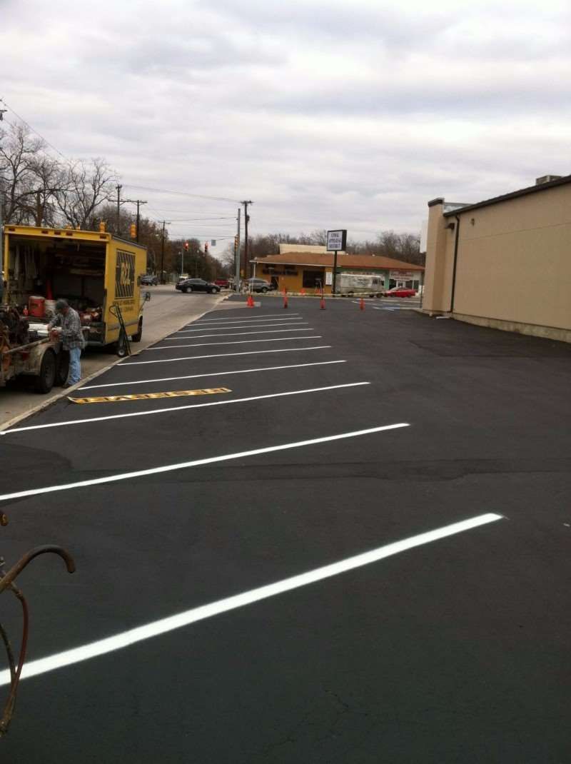 A yellow truck is parked in a parking lot