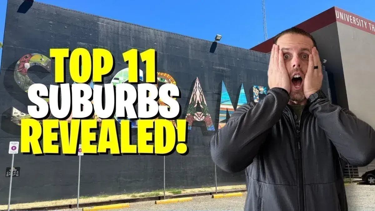 Man shocked in front of mural with bold text: “TOP 11 SUBURBS REVEALED!”