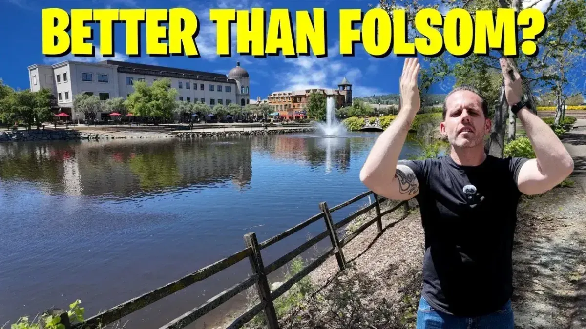Man standing by a river with a building in the background and text reading “BETTER THAN FOLSOM?”