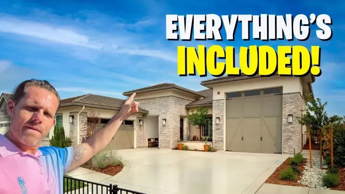 Man gesturing at a house with garage; bold text reads “EVERYTHING’S INCLUDED!”
