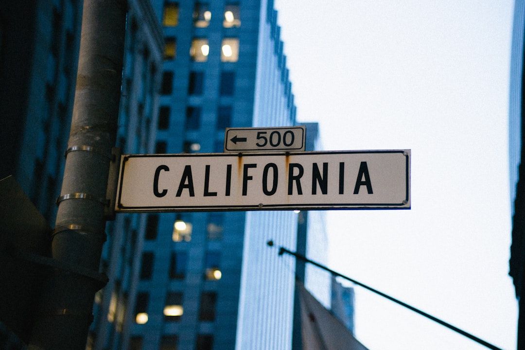 California street sign on a city corner with tall buildings in the background