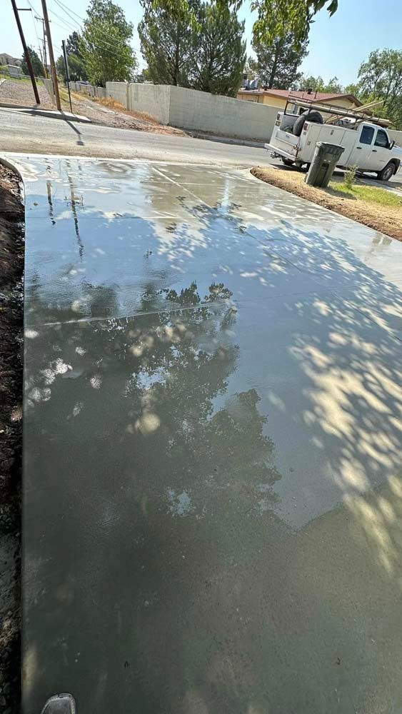 There is a puddle of water on the side of the road.