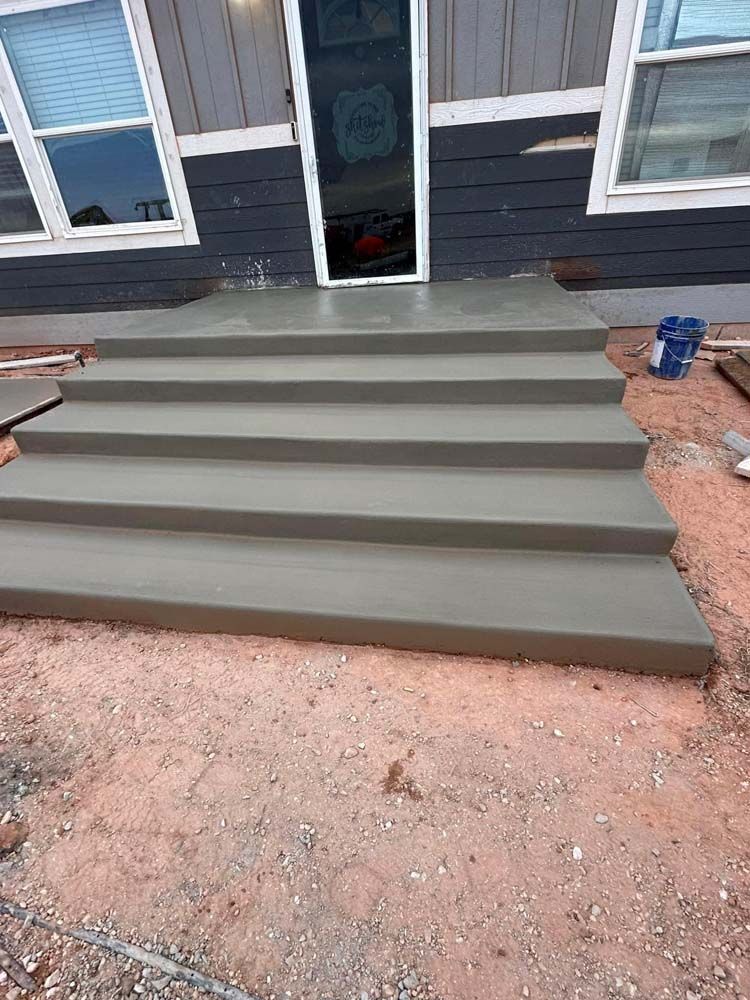 A set of concrete steps leading up to a house.