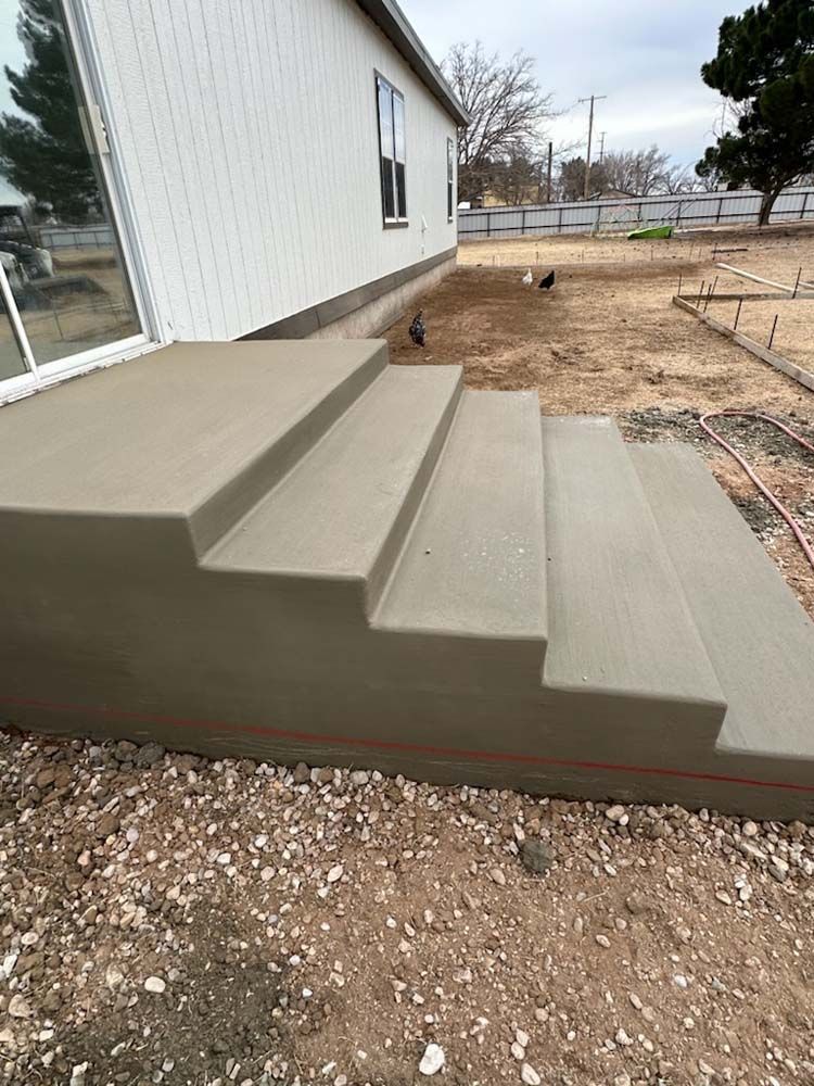 A set of concrete steps leading up to a house.