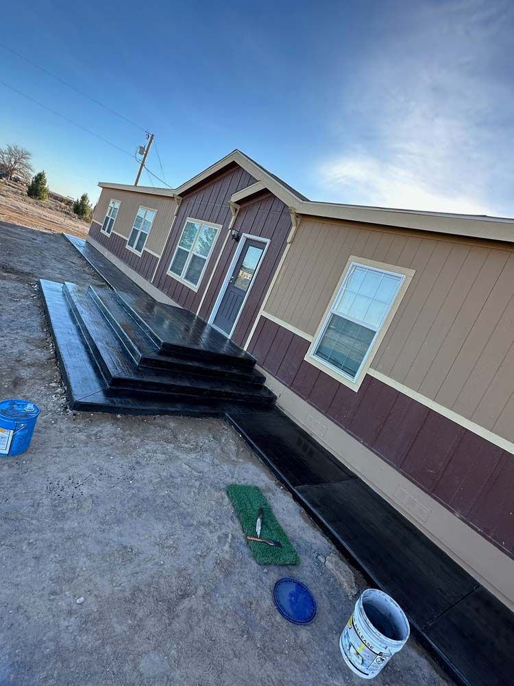 A mobile home is being built in the desert.