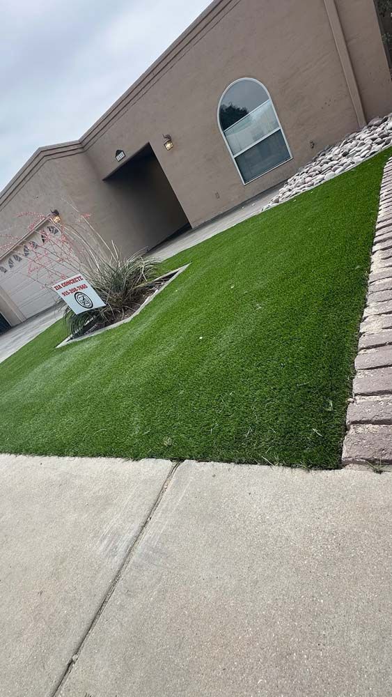 A house with a lush green lawn in front of it.