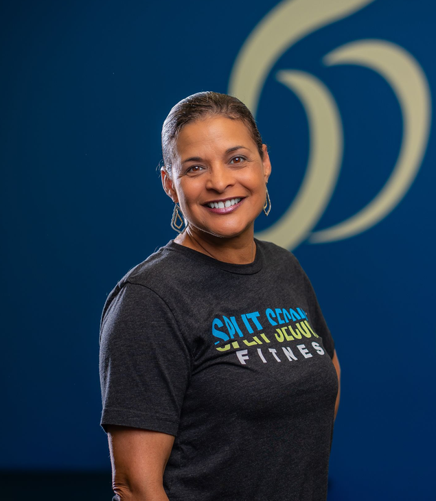 A woman in a black shirt is smiling.