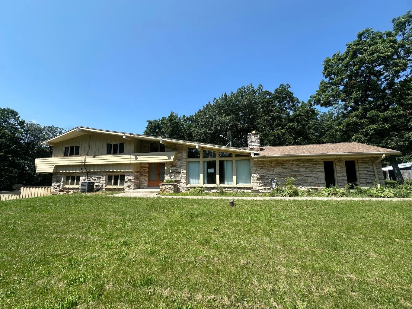 A large house with a large lawn in front of it