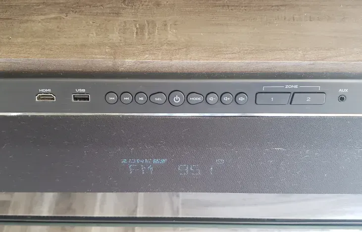 a close up of a remote control on a wooden table .