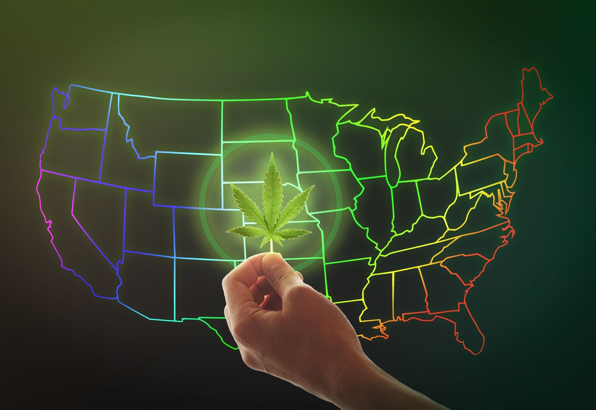 Hand holding marijuana leaf over a neon-outlined United States map.