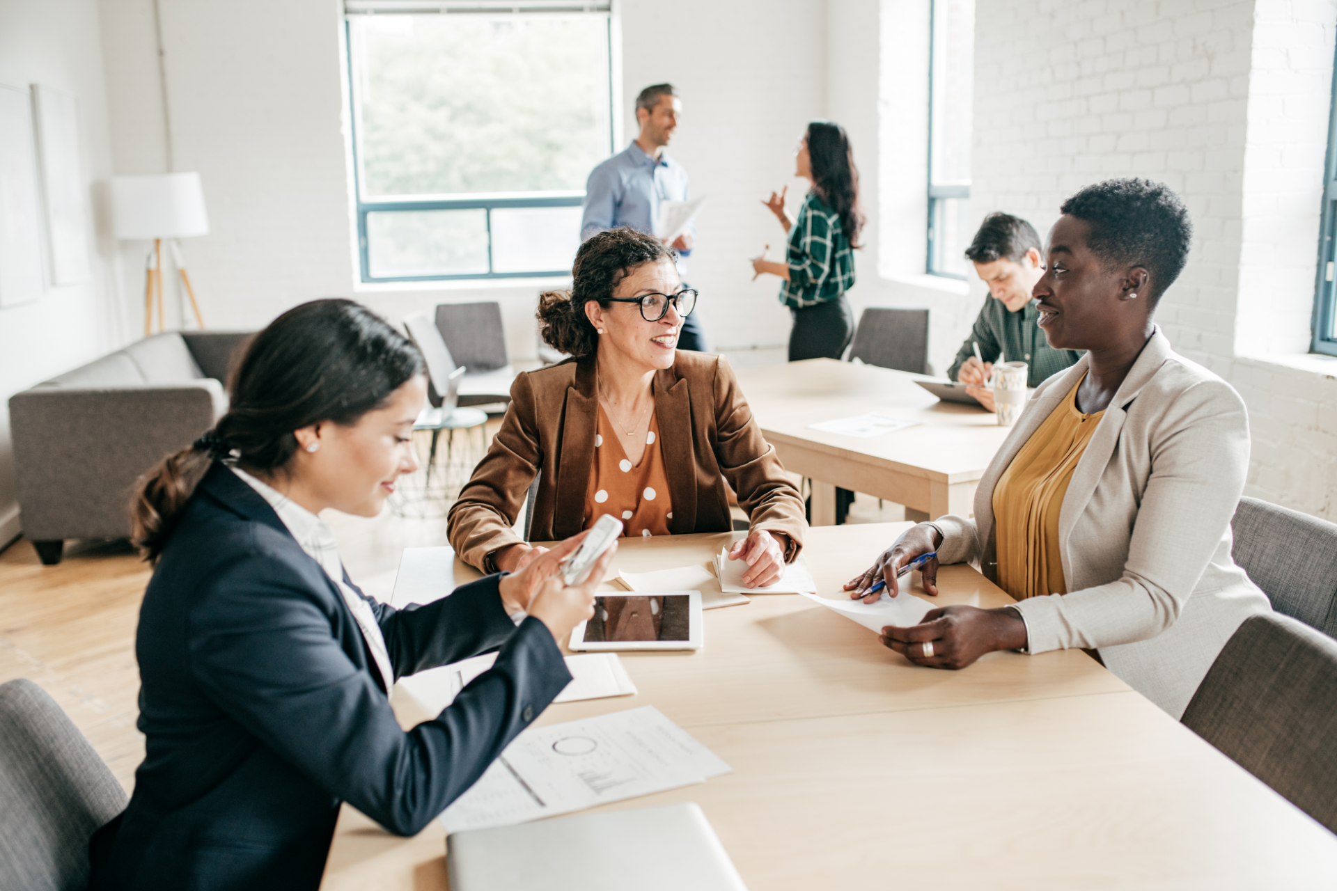 People collaborating at a conference table in a bright office