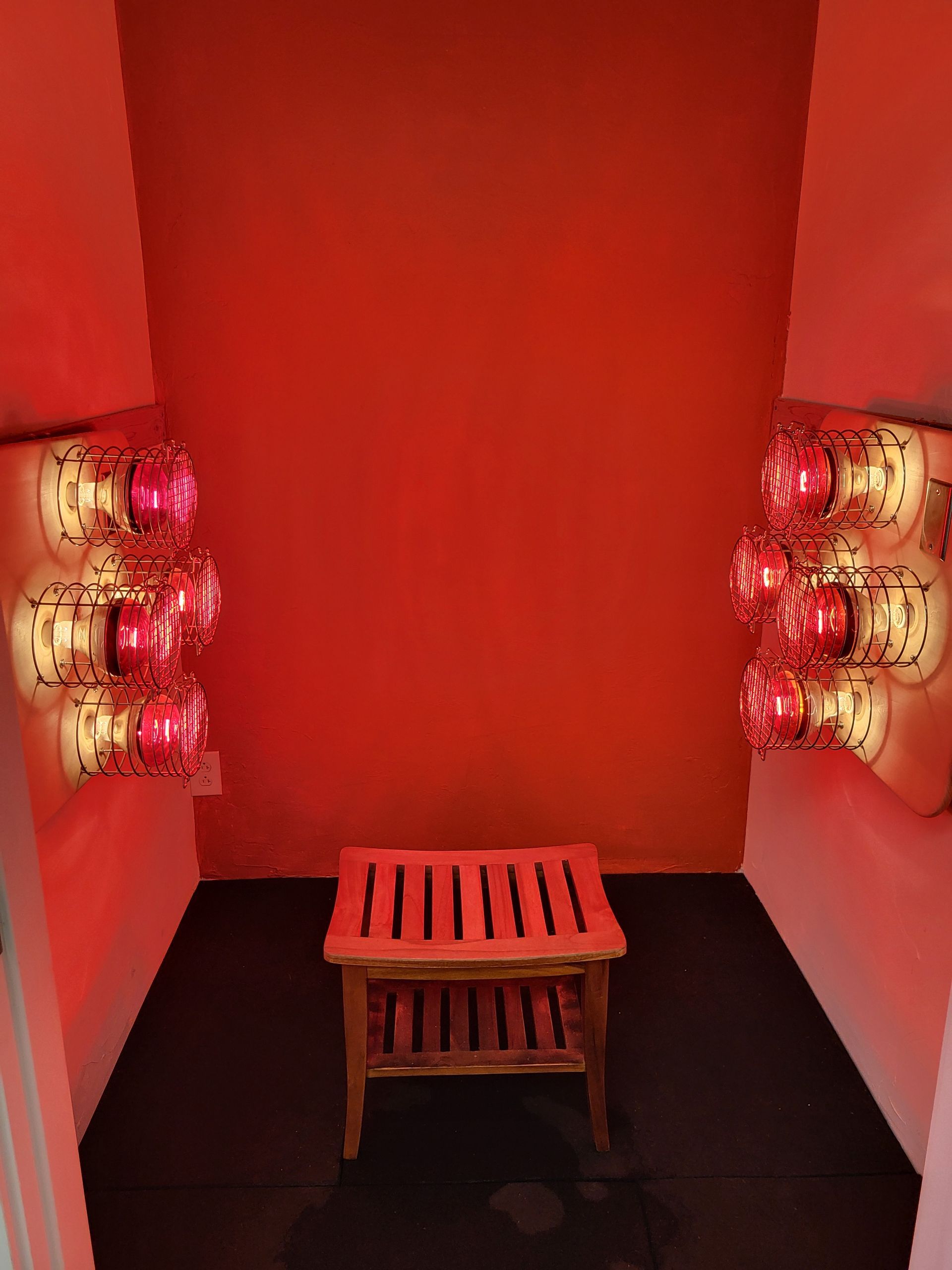 near infrared sauna with a wooden stool in the middle