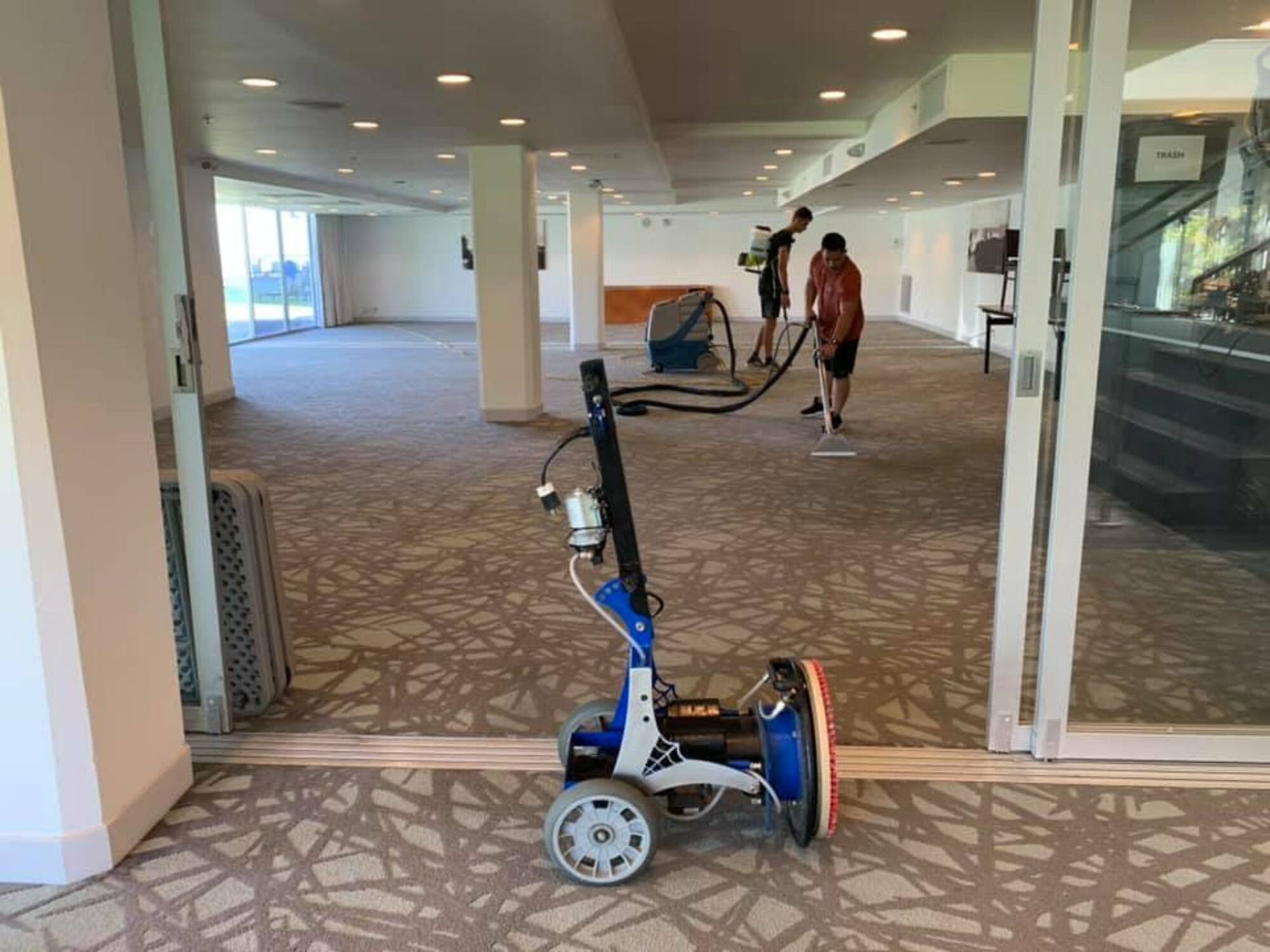 A vacuum cleaner is sitting on the floor in an empty room.