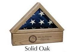 Solid oak triangular folded flag display case with an American flag and engraved plaque.
