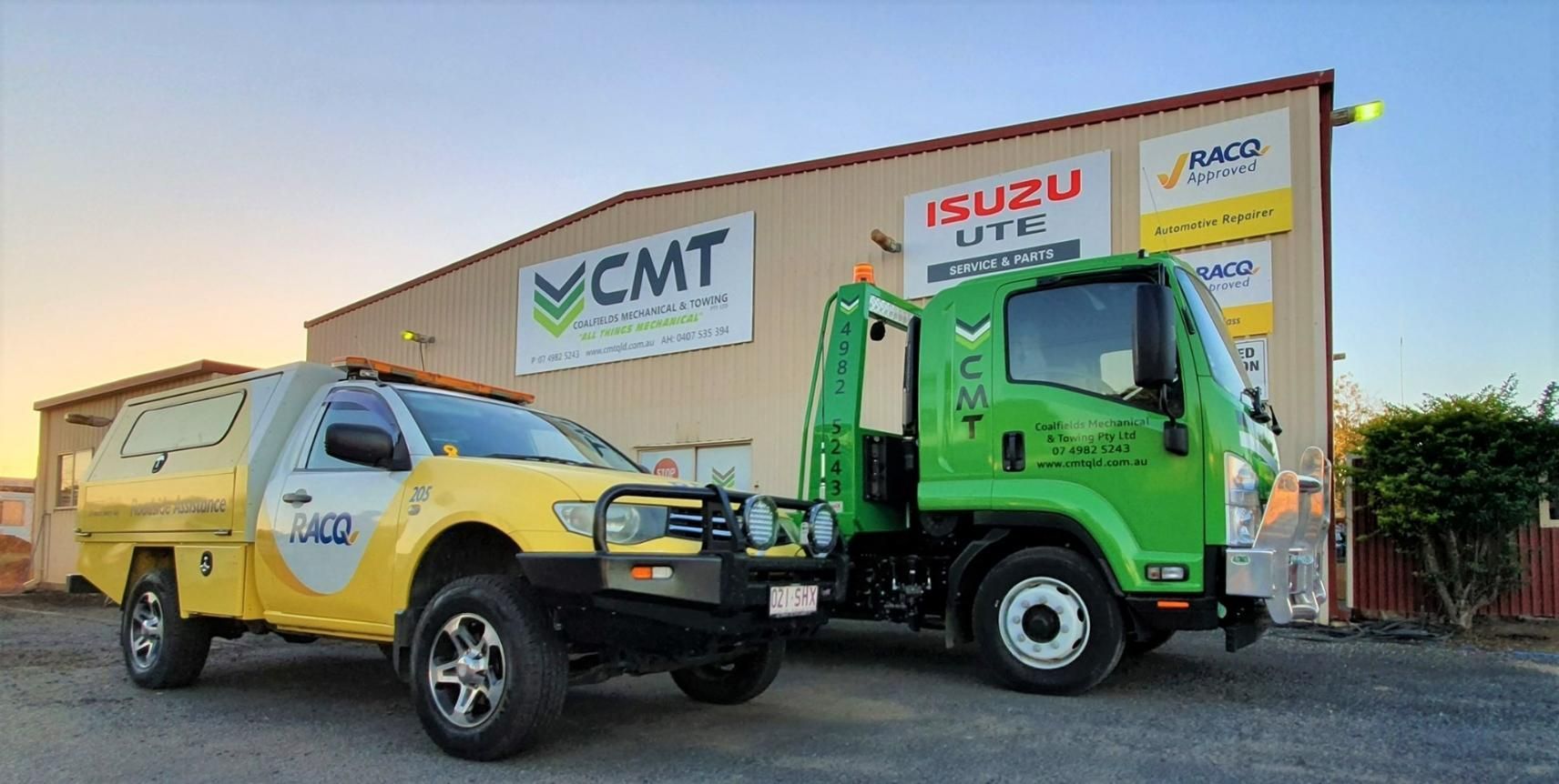 Two Tow Trucks Are Parked in Front of A Building — Coalfields Mechanical & Towing in Blackwater, QLD