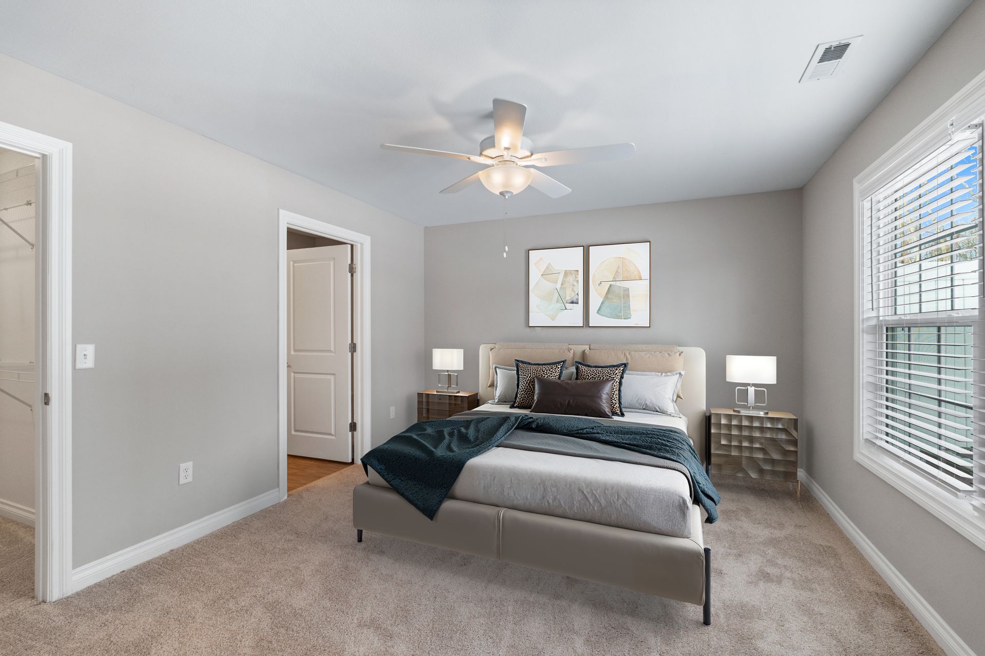 Bedroom with bed, nightstands, window, ceiling fan, neutral colors.
