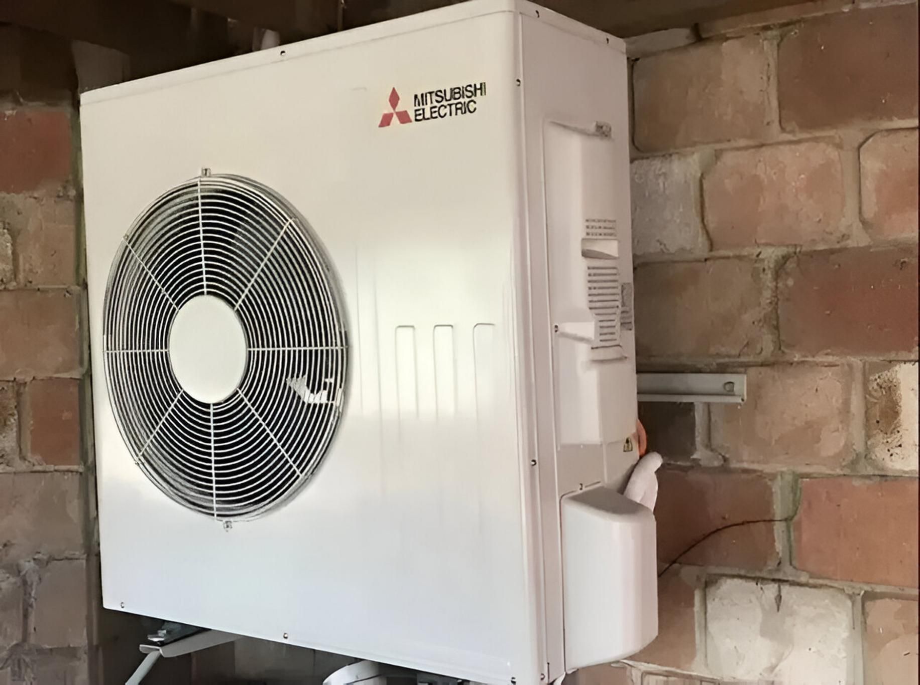 A Mitsubishi Electric Air Conditioner is Mounted to a Brick Wall — Todd Hayes Refrigeration & Air Conditioning Pty Ltd in Kyogle, NSW