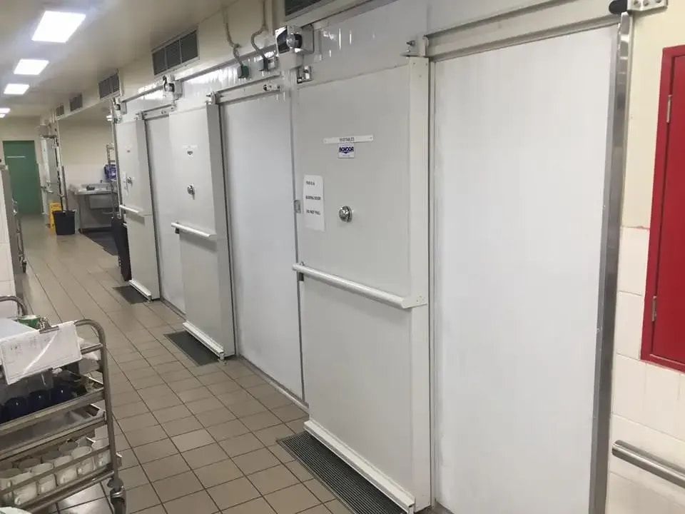 A Row of White Sliding Doors in a Kitchen — Todd Hayes Refrigeration & Air Conditioning Pty Ltd in Kyogle, NSW